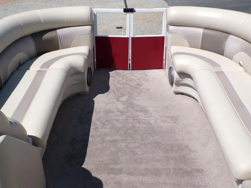 Slide: The Image of Interior of 2013 JC Limited 221 Triple pontoon boat with beige seating and red gate. - 9