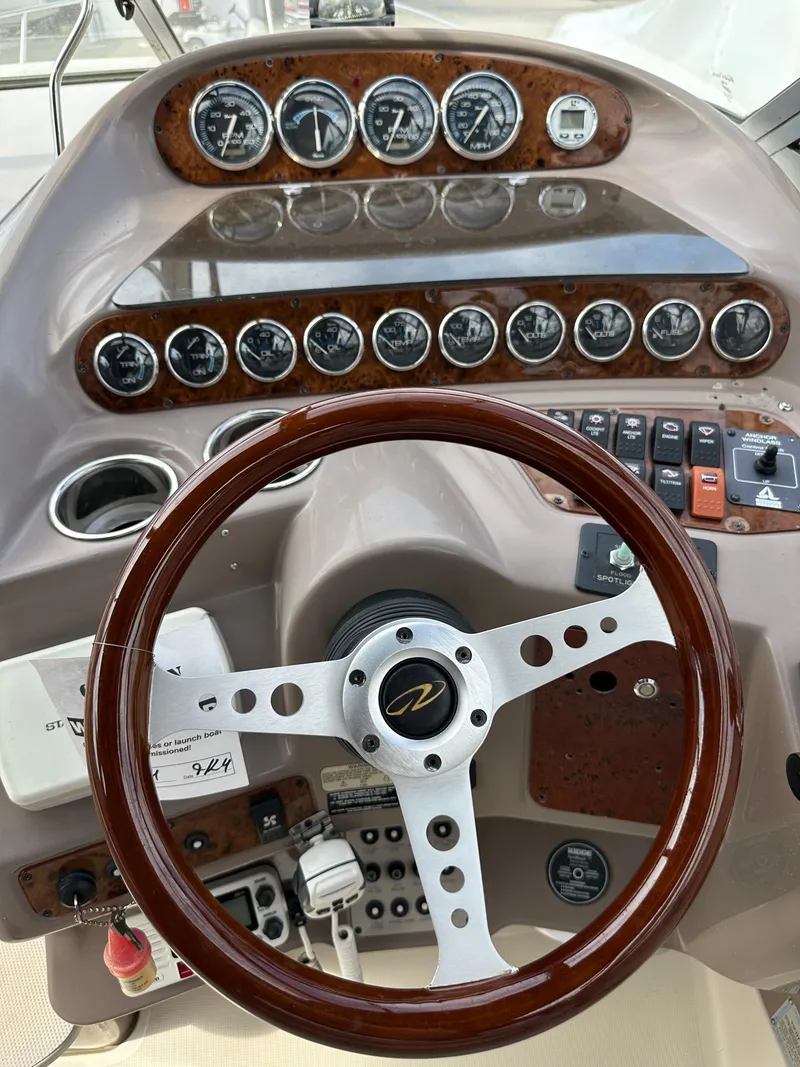 Slide: The Image of Dashboard of a 1998 Regal 2760 Commodore boat with gauges and controls. - 11