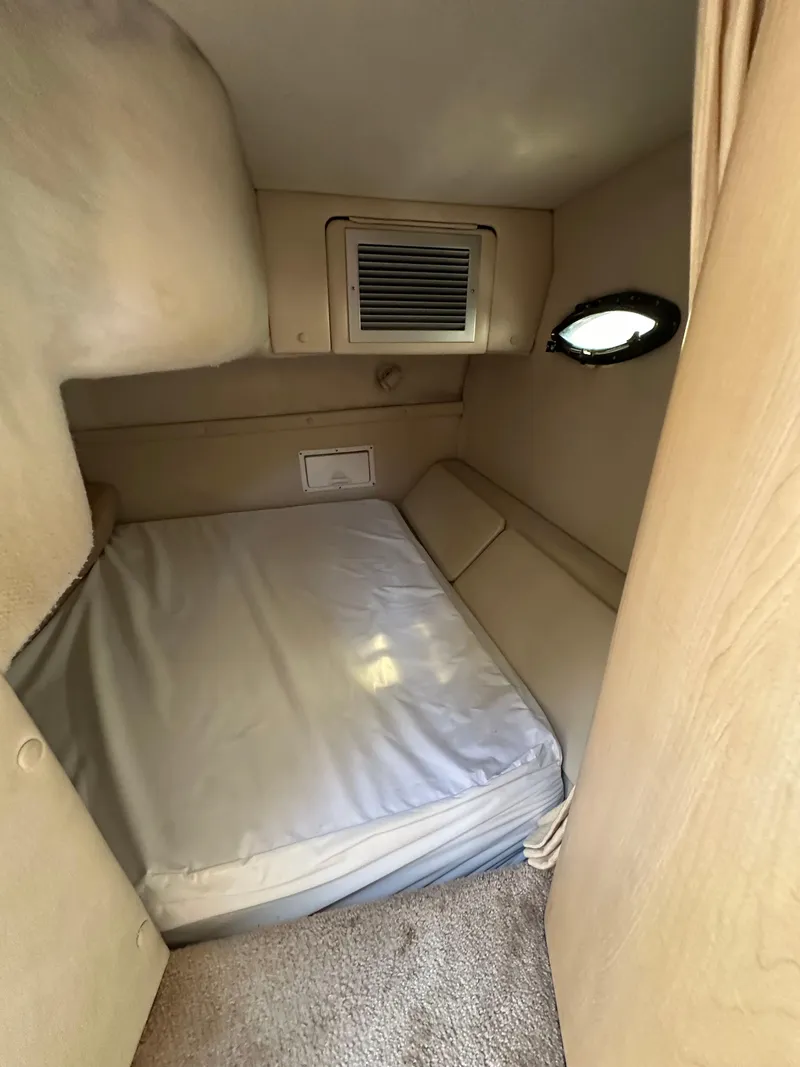 Slide: The Image of 1998 Regal 2760 Commodore cabin interior with bed and small window. - 16