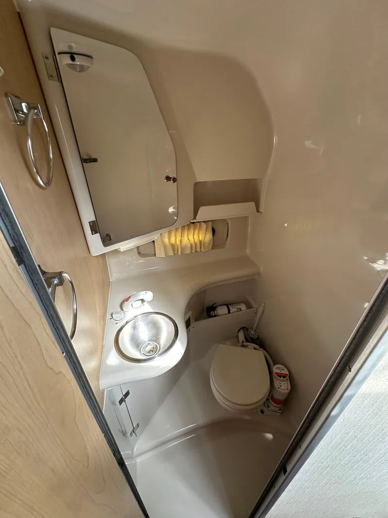 Slide: The Image of 1998 Regal 2760 Commodore boat bathroom with sink, mirror, and toilet. - 18