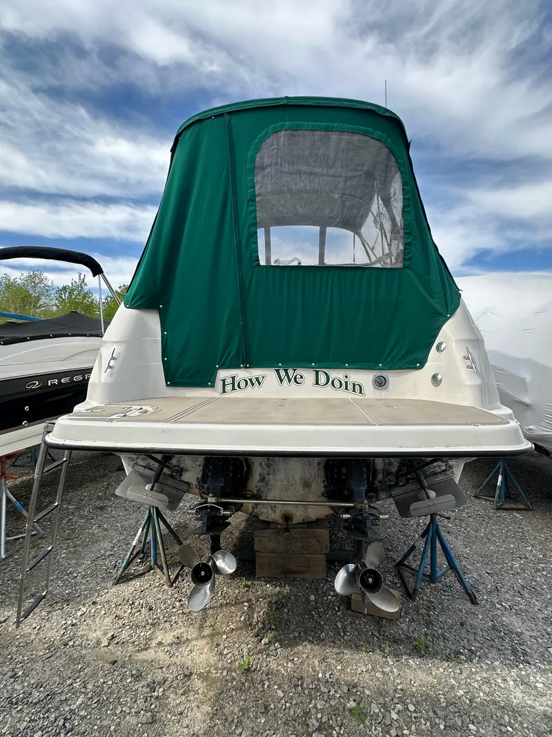 Slide: The Image of 1998 Regal 2760 Commodore boat with green canopy, rear view. - 4
