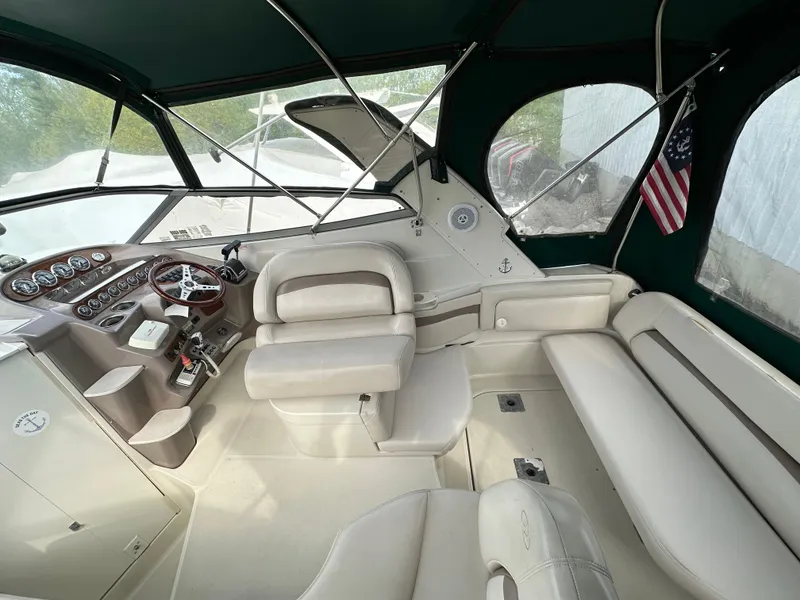 Slide: The Image of 1998 Regal 2760 Commodore boat interior with steering wheel, seating, and American flag. - 7