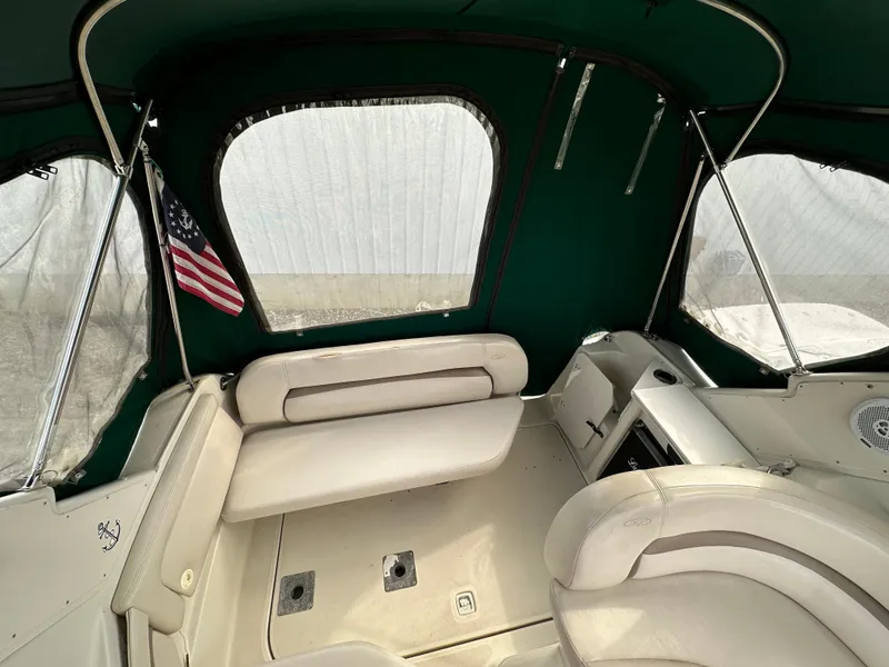 Slide: The Image of Interior of 1998 Regal 2760 Commodore boat with seating and American flag. - 8