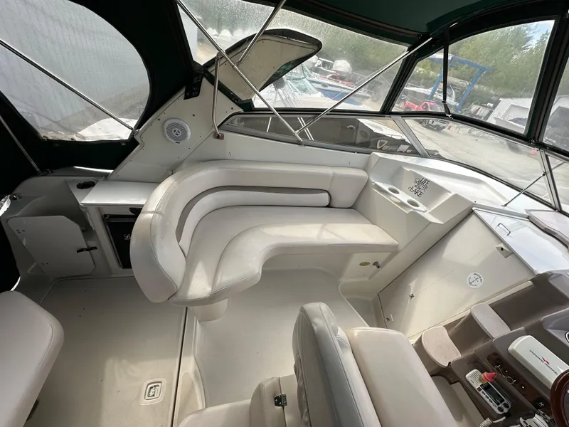 Slide: The Image of 1998 Regal 2760 Commodore boat interior with white seating and helm area. - 9