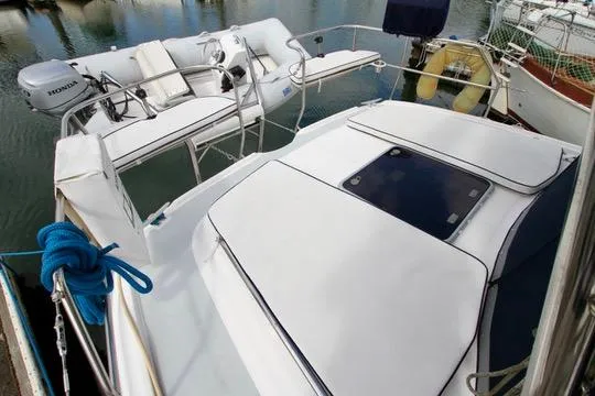 Slide: The Image of 2001 Hunter Passage 420 sailboat deck with seating and motor, docked in marina. - 17