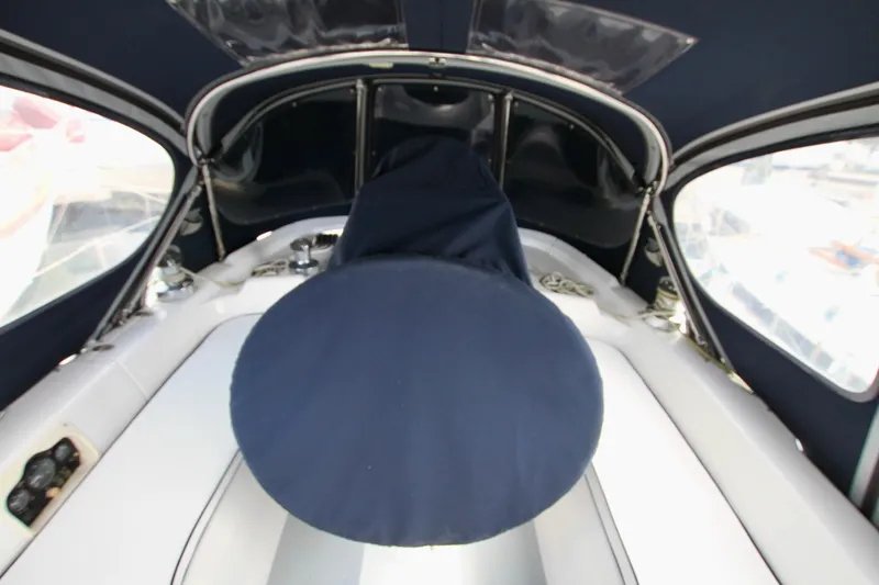 Slide: The Image of Interior view of a 2001 Hunter Passage 420 sailboat cockpit with blue canvas cover. - 23