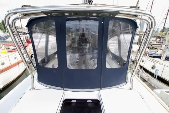 Slide: The Image of 2001 Hunter Passage 420 yacht with blue canvas enclosure in marina. - 24