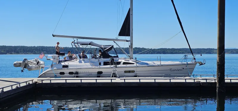 Slide: The Image of 2001 Hunter Passage 420 sailboat docked on a sunny day, with people on deck. - 3