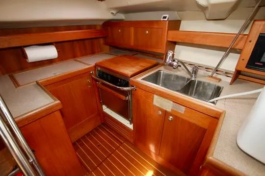 Slide: The Image of 2001 Hunter Passage 420 yacht kitchen with wood cabinetry and stainless steel sink. - 35