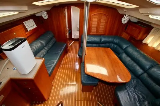 Slide: The Image of Interior of 2001 Hunter Passage 420 yacht with wooden furnishings and blue seating. - 36