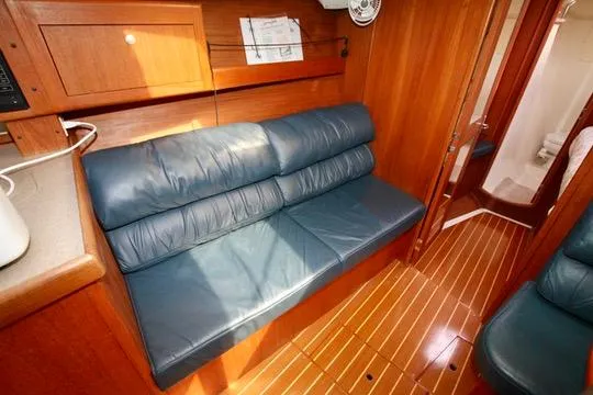 Slide: The Image of Interior of 2001 Hunter Passage 420 yacht with blue leather seating and wooden flooring. - 38