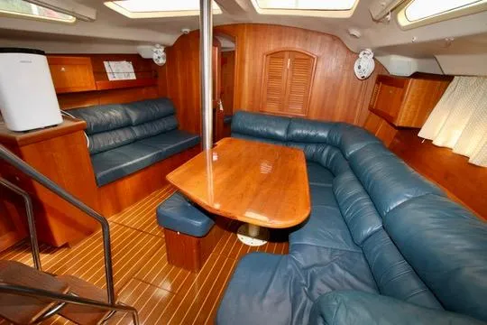 Slide: The Image of Interior of 2001 Hunter Passage 420 yacht with wooden furnishings and blue seating. - 39