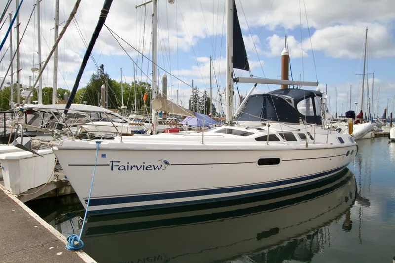 Slide: The Image of 2001 Hunter Passage 420 sailboat docked in a marina, under a partly cloudy sky. - 4