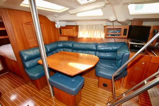 Slide: The Image of Interior of 2001 Hunter Passage 420 yacht with blue leather seating and wooden furnishings. - 42