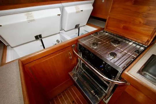 Slide: The Image of Galley kitchen in 2001 Hunter Passage 420 yacht with stove and storage compartments. - 45