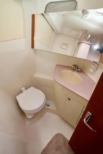 Slide: The Image of 2001 Hunter Passage 420 yacht bathroom with sink, mirror, and toilet. - 47