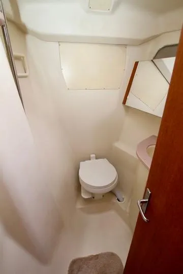 Slide: The Image of 2001 Hunter Passage 420 yacht bathroom with toilet, sink, and mirror. - 48
