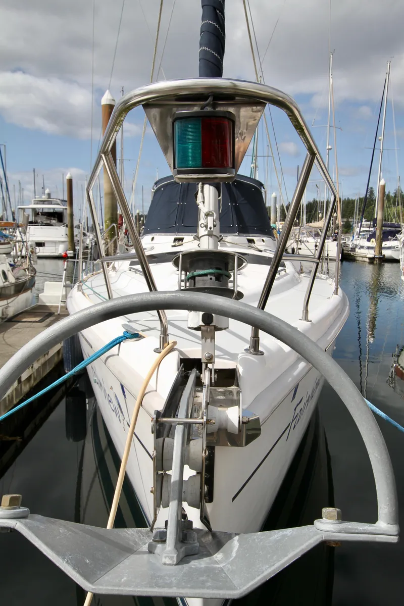 Slide: The Image of 2001 Hunter Passage 420 sailboat docked in marina, front view with anchor and navigation light. - 5