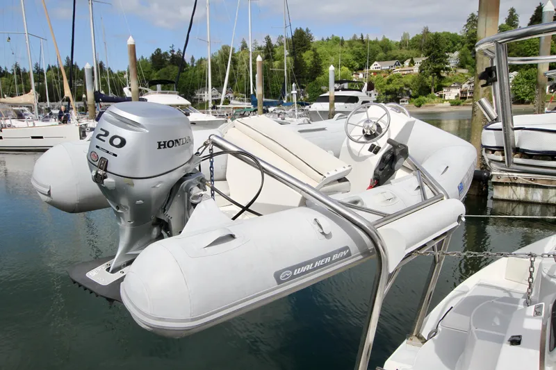 Slide: The Image of Inflatable boat with Honda motor docked near a 2001 Hunter Passage 420 yacht. - 6