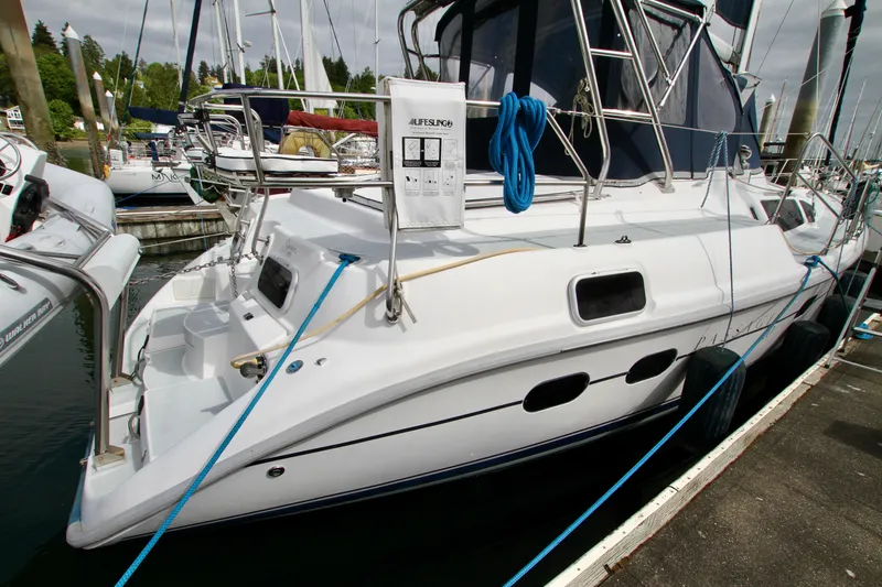 Slide: The Image of 2001 Hunter Passage 420 yacht docked at marina, featuring sleek design and blue ropes. - 7