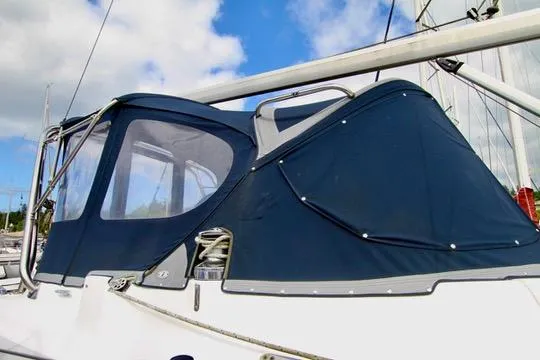 Slide: The Image of 2001 Hunter Passage 420 sailboat with blue canvas cover and clear windows. - 8