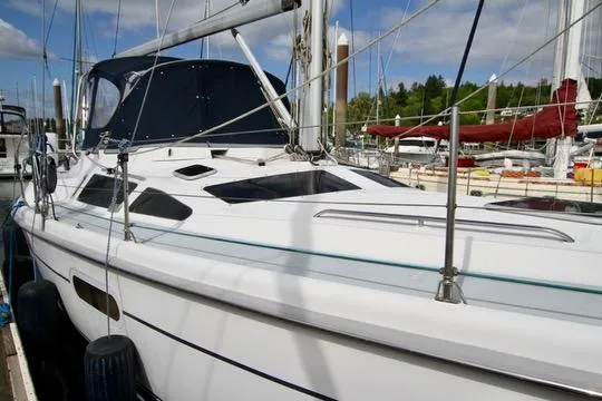 Slide: The Image of 2001 Hunter Passage 420 sailboat docked at marina, featuring sleek white design and spacious deck. - 9