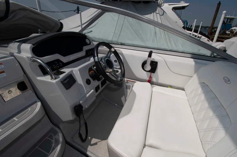Slide: The Image of 2020 Regal 26 XO boat cockpit with steering wheel and white seating. - 5