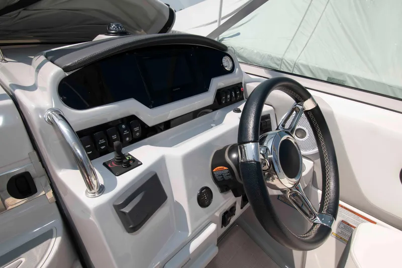 Slide: The Image of 2020 Regal 26 XO boat dashboard with steering wheel and control panel. - 6