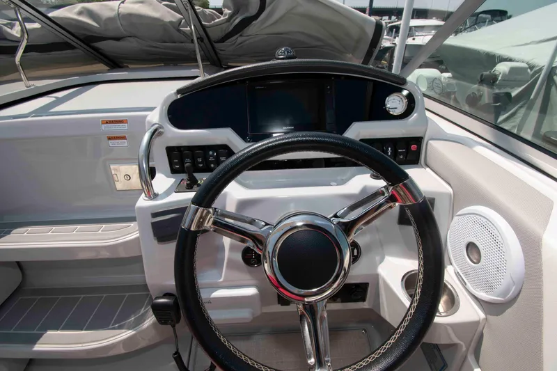 Slide: The Image of 2020 Regal 26 XO boat dashboard with steering wheel and control panel. - 7