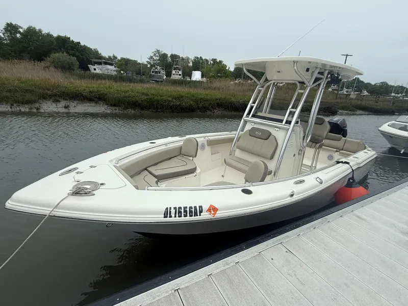 Slide: The Image of 2024 Key West 239 FS boat docked on a calm waterway. - 1