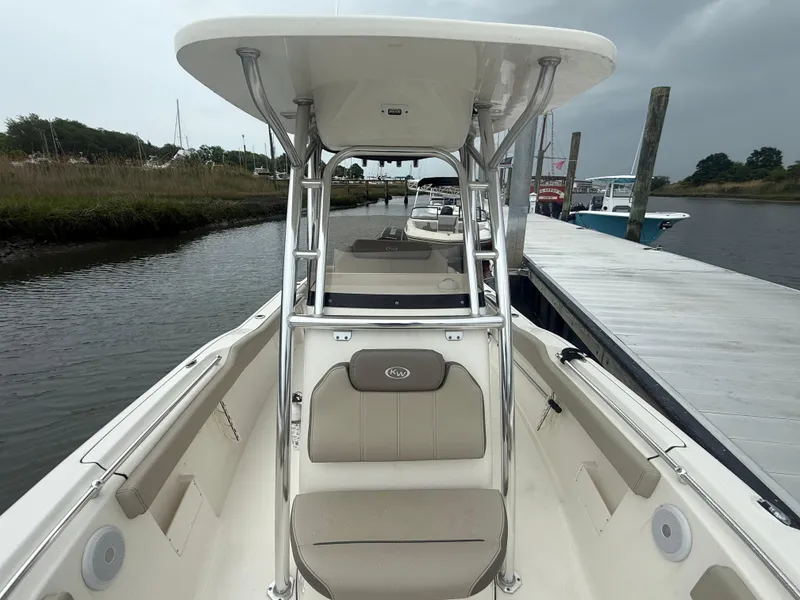Slide: The Image of 2024 Key West 239 FS boat docked, featuring spacious seating and sleek design. - 10