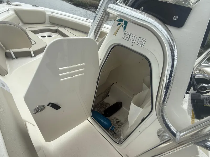 Slide: The Image of 2024 Key West 239 FS boat interior storage compartment with open door. - 11