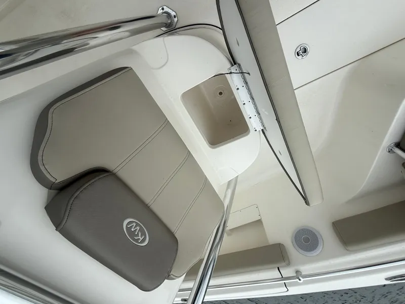 Slide: The Image of 2024 Key West 239 FS boat interior with cushioned seating and storage compartment. - 14