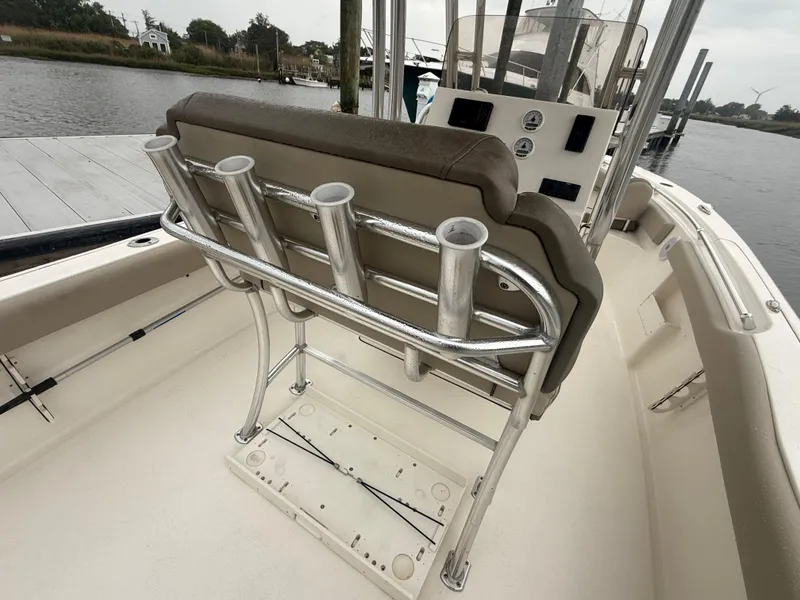 Slide: The Image of 2024 Key West 239 FS boat interior with rod holders and control panel by the water. - 18