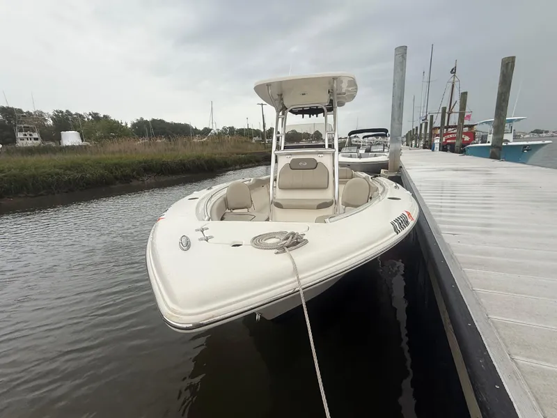 Slide: The Image of 2024 Key West 239 FS boat docked on a calm waterway under a cloudy sky. - 19