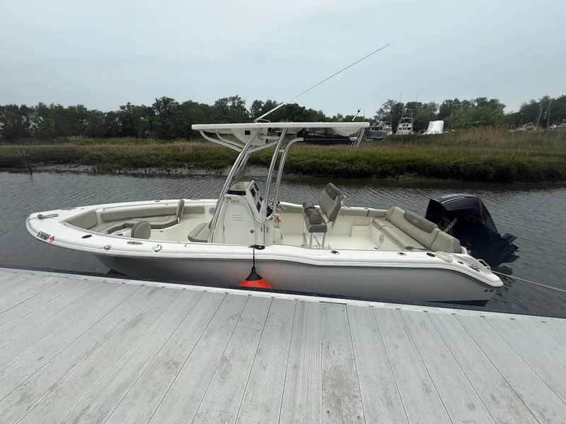 Slide: The Image of 2024 Key West 239 FS boat docked on a calm river with lush greenery. - 2