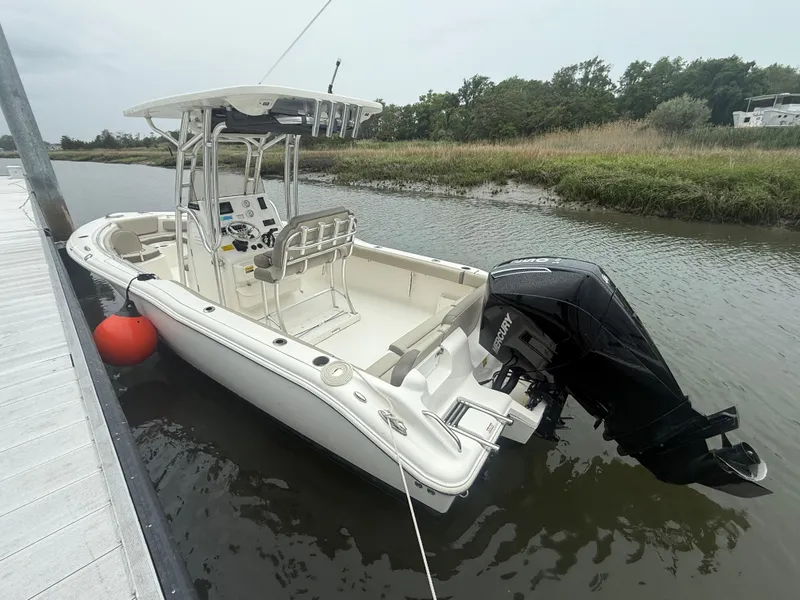Slide: The Image of 2024 Key West 239 FS boat docked on a calm river with lush greenery. - 3