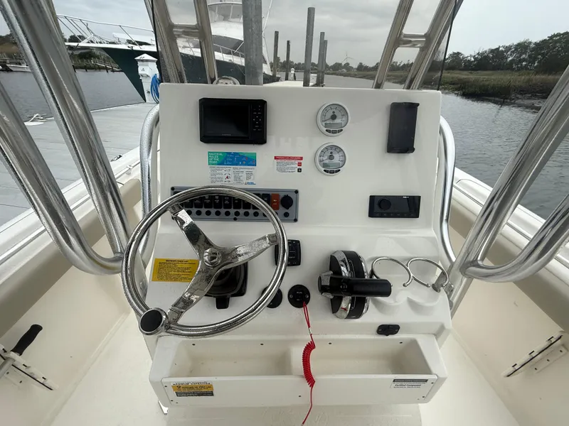 Slide: The Image of 2024 Key West 239 FS boat console with steering wheel and gauges. - 6