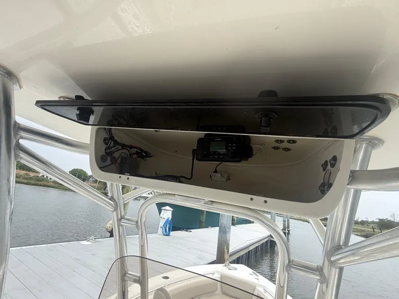 Slide: The Image of 2024 Key West 239 FS boat console with electronics, docked by a calm waterfront. - 7