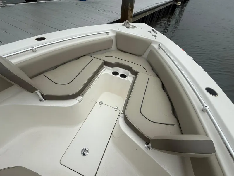 Slide: The Image of 2024 Key West 239 FS boat interior with cushioned seating and storage compartments. - 8
