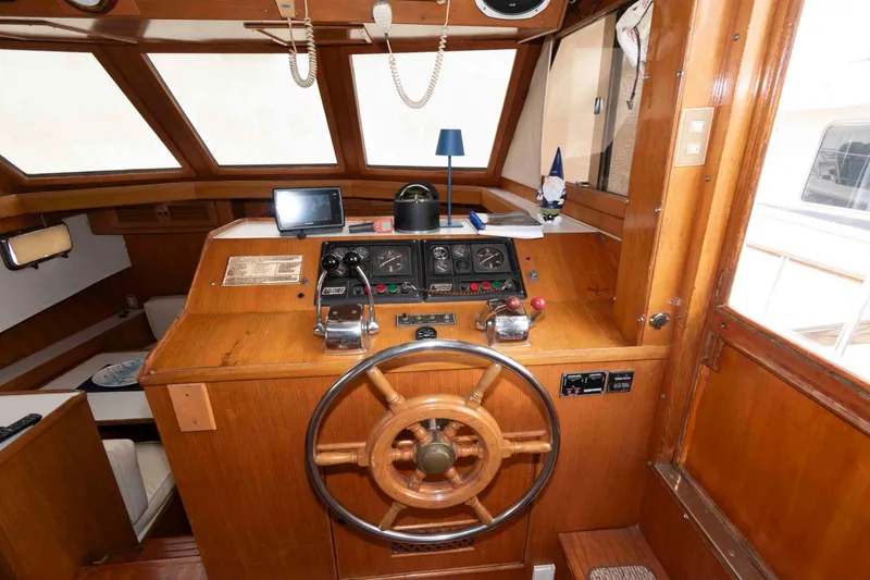 Slide: The Image of 1988 Marine Trader 48 Trawler helm with wooden wheel and navigation instruments. - 15