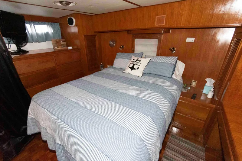 Slide: The Image of Cozy bedroom in 1988 Marine Trader 48 Trawler with striped bedding and nautical decor. - 20