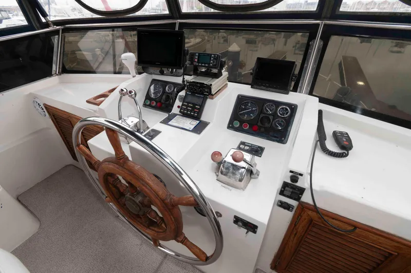 Slide: The Image of 1988 Marine Trader 48 Trawler helm with wooden wheel and navigation instruments. - 9