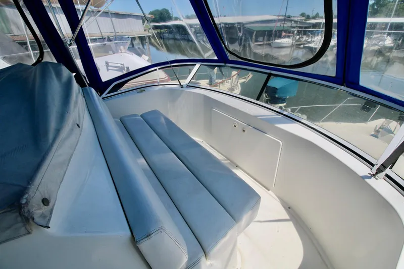 Slide: The Image of 1997 Silverton 372 Motor Yacht interior with cushioned seating and blue canopy. - 10