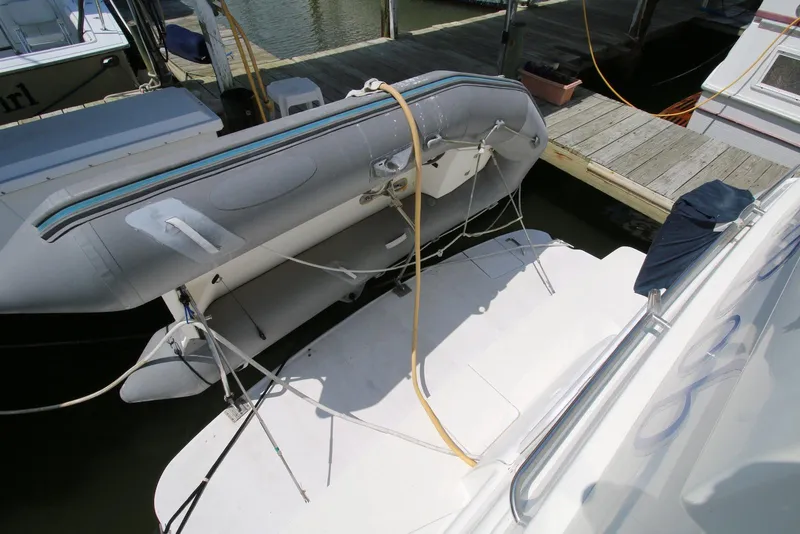 Slide: The Image of 1997 Silverton 372 Motor Yacht with inflatable dinghy on deck at marina. - 11