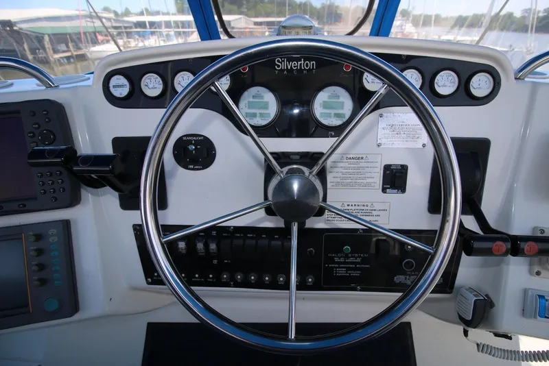 Slide: The Image of 1997 Silverton 372 Motor Yacht helm with steering wheel and instrument panel. - 13