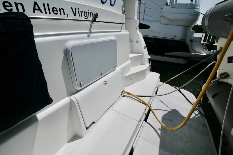 Slide: The Image of 1997 Silverton 372 Motor Yacht docked, showing deck details and power connections. - 17
