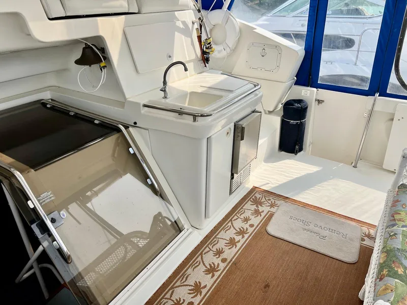 Slide: The Image of 1997 Silverton 372 Motor Yacht interior with sink, storage, and seating area. - 18