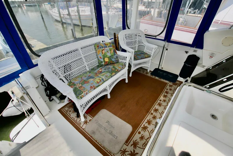 Slide: The Image of 1997 Silverton 372 Motor Yacht interior with wicker seating and nautical decor. - 19