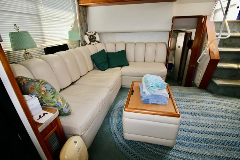 Slide: The Image of Interior of 1997 Silverton 372 Motor Yacht with cozy seating and nautical decor. - 22